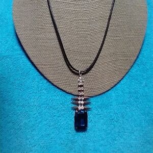 Goldtone blue and clear crystal spike necklace on black cord